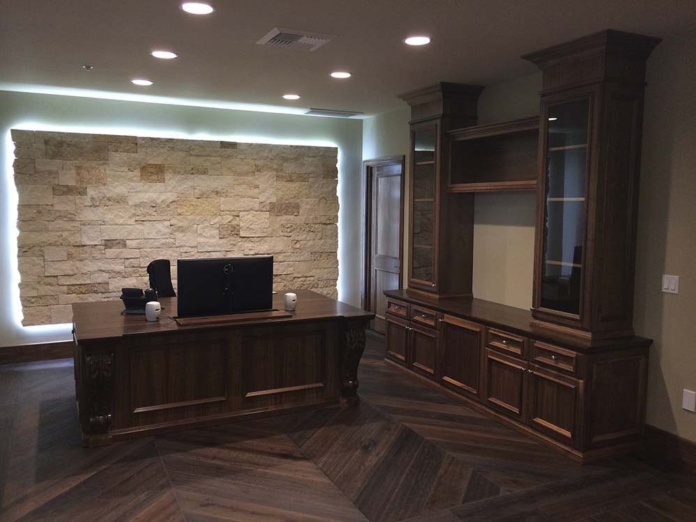 Executive Office Suite: private office with lit stone wall