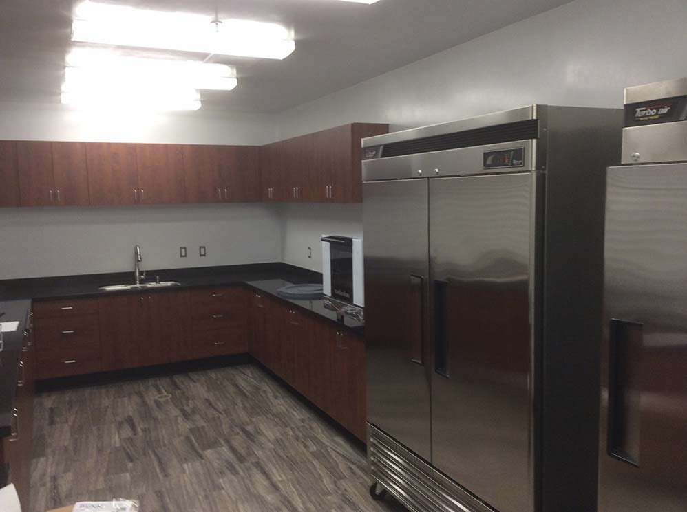 RSD Headquarters: Staff kitchen with stainless refrigerator